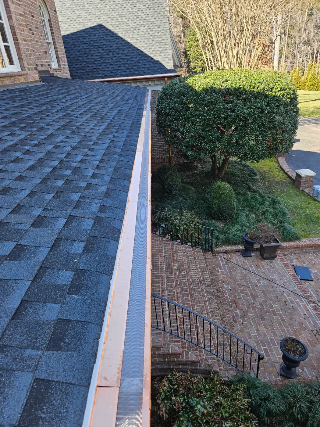 elite-home-services-nc-copper-gutter-guard-brick-patio-steps.webp