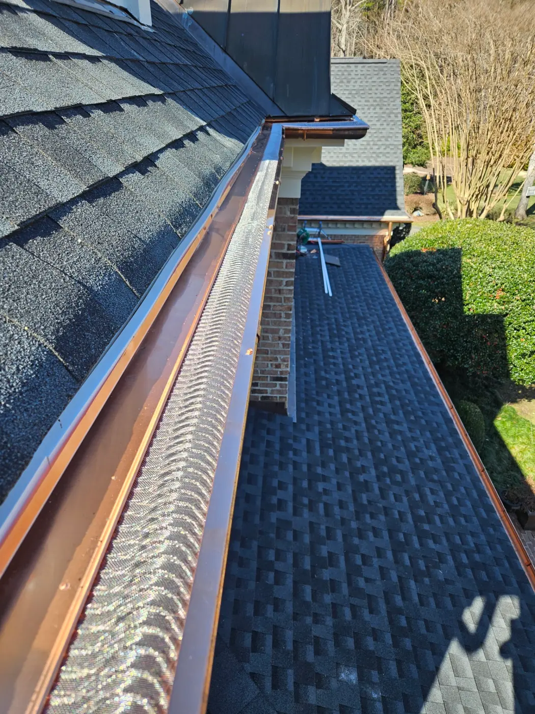 elite-home-services-nc-copper-gutter-guard-chimney-lower-roof.webp