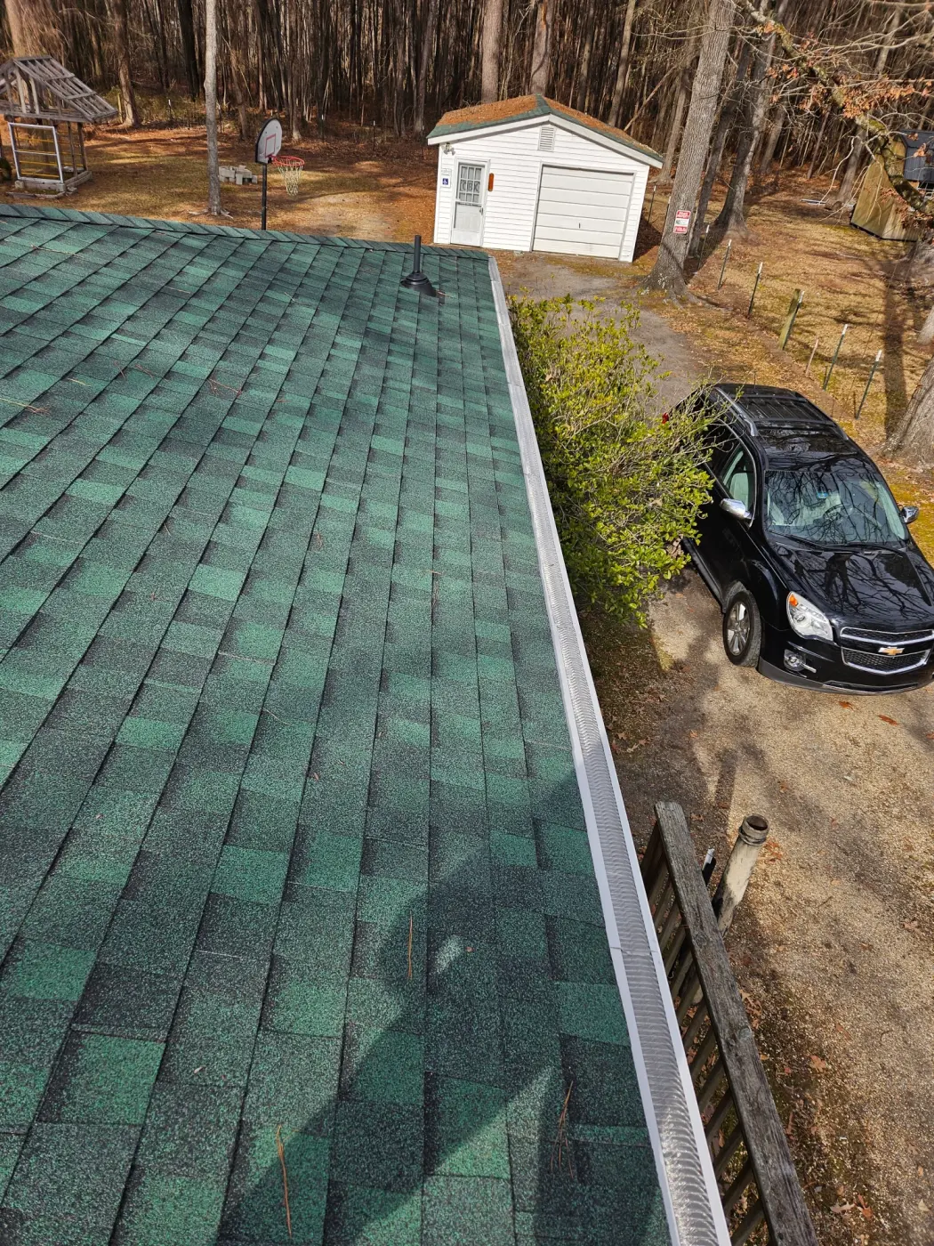 elite-home-services-nc-gutter-guard-installed-green-roof-shed.webp