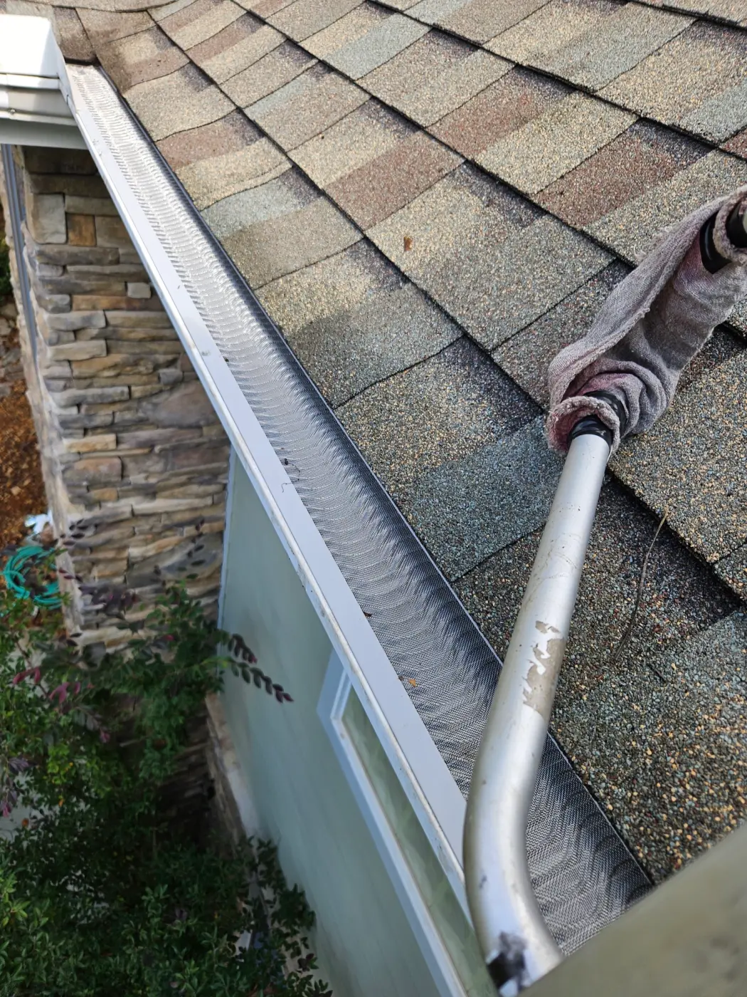elite-home-services-nc-gutter-guard-stone-veneer-siding.webp