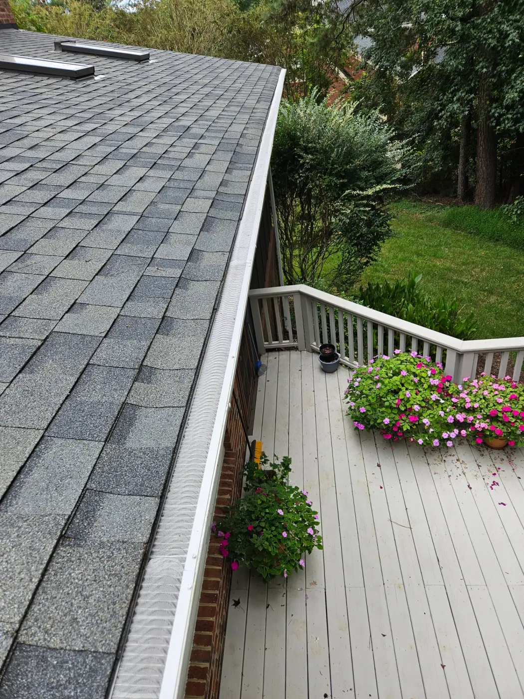 elite-home-services-nc-roof-gutter-guard-deck-flowers.webp