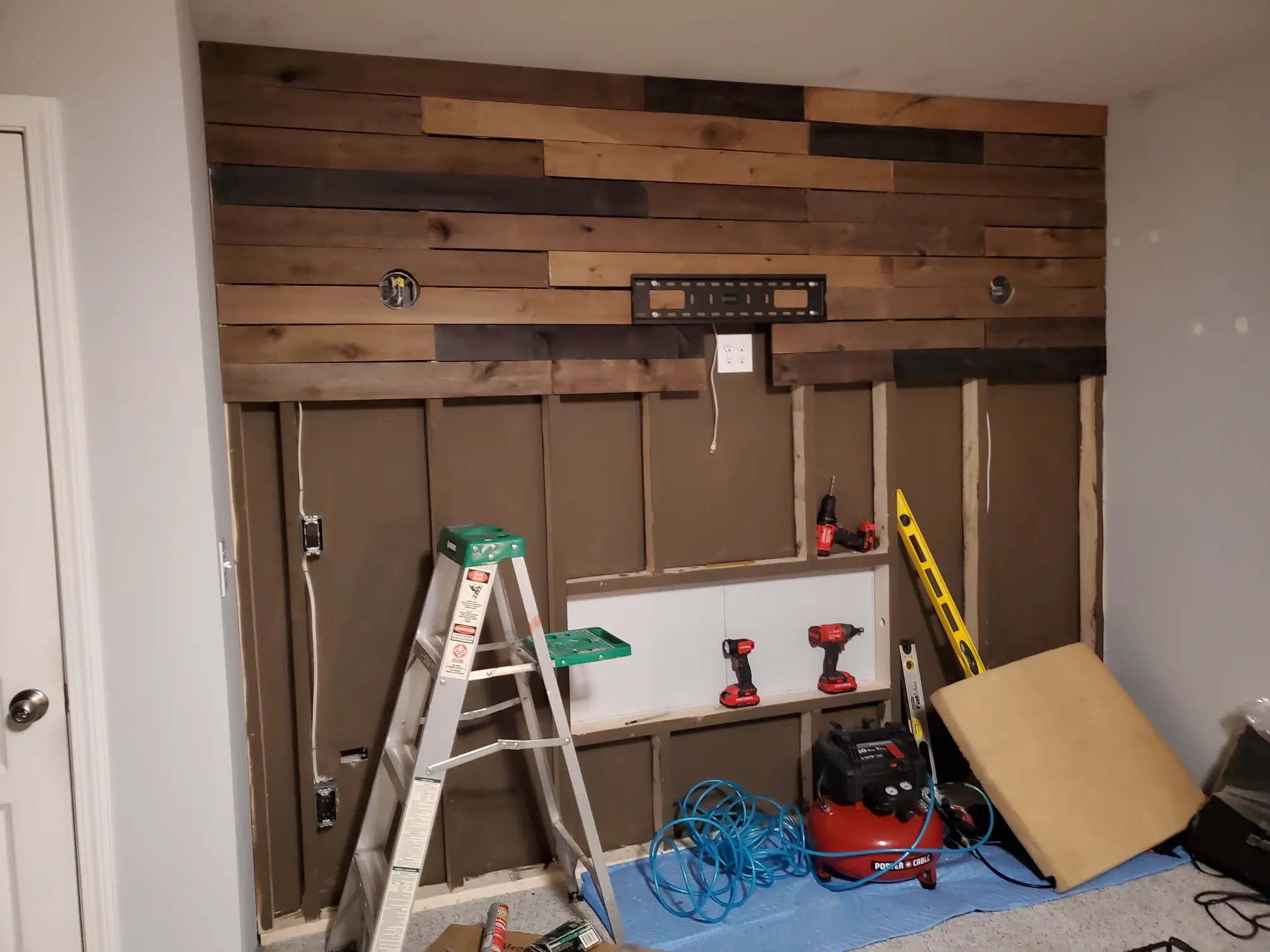 elite-home-services-nc-reclaimed-wood-accent-wall-installation-in-progress.webp