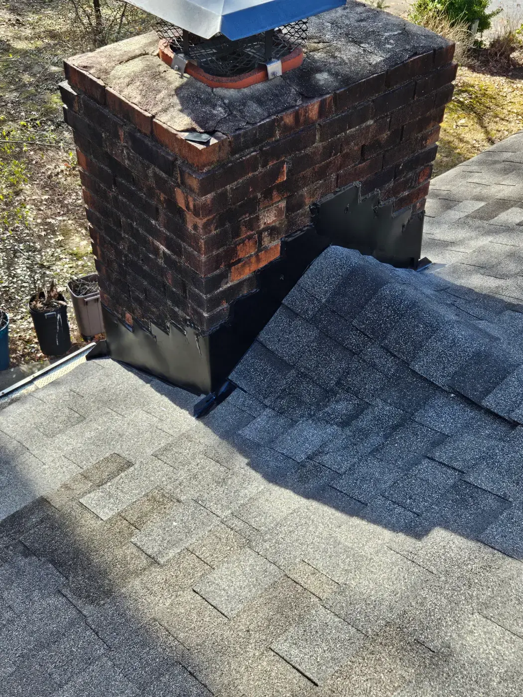 elite-home-services-nc-chimney-step-flashing-brick-closeup.webp